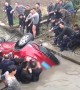 Good Samaritans rescue driver trapped in car flipped into river