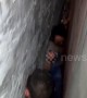 Claustrophobics look away! Man gets trapped between two walls trying to get dropped eggs