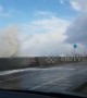 Waves crash over seafront onto passing cars in New Brighton in UK