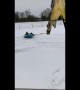 Workers take a spin in the snow with aid of excavator