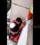 Firemen save girl hanging out of window on third floor of residential building