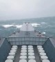 Navy ship battles huge waves at sea