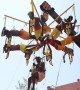 Hindu devotees display their devotion by piercing skin with metal hooks and hanging from crane