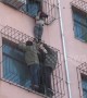 Chinese firemen rescue boy hanging from fourth-floor window of residential building