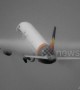 Condensation clouds engulf plane's wings as it takes off from Manchester Airport