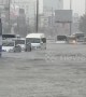 Cars travel through flooded roads in Thai city