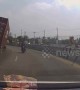 Quick-thinking motorbike rider narrowly avoids being crushed by 40ft long shipping container