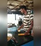 Indian paratha cook casually tosses dough over his shoulder to other chef