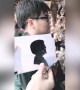 Astonishing Chinese street artist cuts paper profiles in one minute