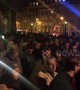 Parisians gather and sing hymns on the Tournelle Bridge opposite Notre Dame