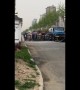 Bizarre moment moped riders patiently drive behind van spraying water in China