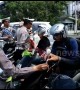 Indonesian police remind road users to take care by handing out flowers