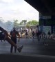 Clashes in Caracas continue as rocks are thrown at motorcyclists and huge fences are destroyed