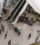 Debris plunges from fifth floor escalator as heavy rain batters Philippines shopping mall