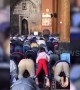 Watch playful girl riding devotee's back during prayer inside mosque in northern India