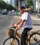 Cyclist takes chicken for a ride during morning rush hour in Thailand