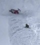 Snowmobile Rider Takes a Spill Down the Hill