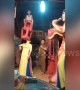Woman in Vietnam uses her mouth to lift a child and chair over her head