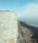 Drone camera spins and rolls in dizzying film of UK cliffside