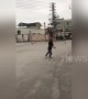 Old Chinese man works out with giant metal hula-hoop