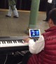 Child prodigy plays Mozart masterpiece while playing a computer game at the same time in New York, USA