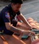 Rescue worker climbs onto roof to rescue 8-foot-long python trapped in between tiles