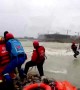 Chinese firefighters rescue workers trapped on flooded digger