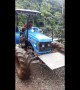 Honduran driver leaps to safety as tractor falls into raging river