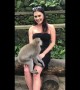 Hilarious moment cheeky monkey pulls down woman's dress exposing her breasts
