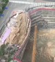 Destroyed road collapses onto a construction site in southern China