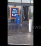 Funny moment man in leopard print gown walks out of Aldi with crate of beer