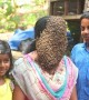 Indian woman covers her face with hundreds of bees to raise conservation awareness