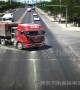 Truck driver narrowly avoids flattening car after changing directions quickly in China