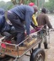 Pedestrians pay 10p to be taken across fast moving flood waters in Kenya