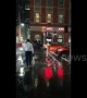 Man attempts to 'fight' rain while standing in the middle of a road in Sydney
