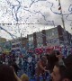 Whacky performers blast UK high street with streamers and confetti