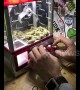 Someone plays marijuana claw crane machine game