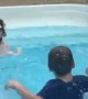 Dog hilariously mimics kids in pool and learns to splash