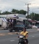 Reckless schoolboys climb onto roof of moving bus on busy road in Thailand