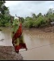 Indian villagers risk their lives by walking on rope above river to reach farmland