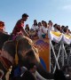 Thai monks ride elephants while receiving donations to mark the start of Buddhist Lent