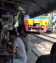 Locals eat at tables just inches from passing trains at Thai restaurant