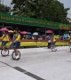 Adorable moment dozens of Thai schoolgirls dance on unicycles at Buddhist festival