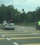 Reckless driver in Malaysia is caught jumping red light with two children clinging to roof