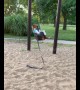 Two pups chill out in children's swing set in Iowa park
