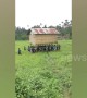 Community effort! Filipino villagers help neighbour carry house to new location