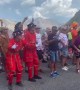 Fans dressed as British Beefeaters dance at the Tour de France