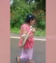 Bizarre moment grandmother, 75, carries live cobra down the road 'while in a trance'