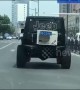 Jeep has air conditioning unit attached to its boot while driving on Chinese road