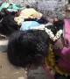 Indian women eat from the floor with hands behind back in bizarre fertility ritual